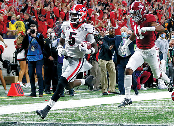 Georgia Bulldogs defensive back Kelee Ringo (5) returns a interception for a touchdown during the College Football Playoff National Championship at Lucas Oil Stadium in Indiana.